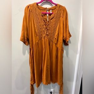 Beautiful boho dress with lace and tie detail in the front.